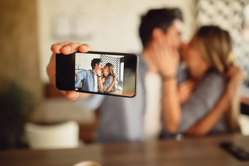 A couple taking an intimate photo of themselves