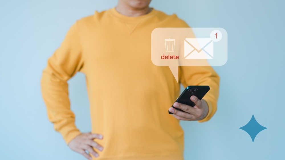 Man holding a mobile phone and viewing messages on mobile phone, Delete messages.
