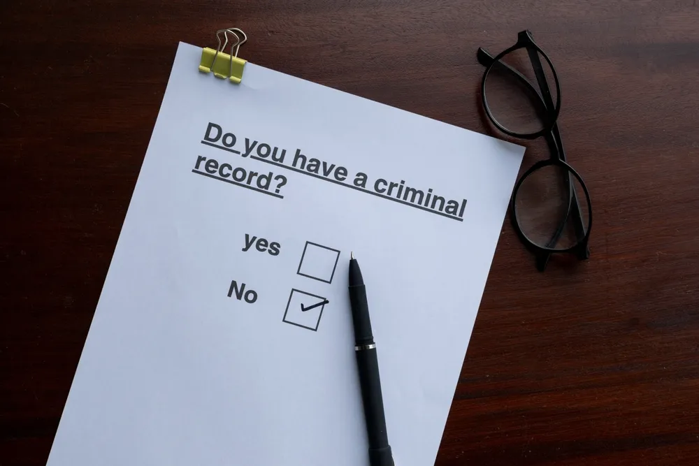 Screening Essentials: Criminal History Form with Pen and Boxes