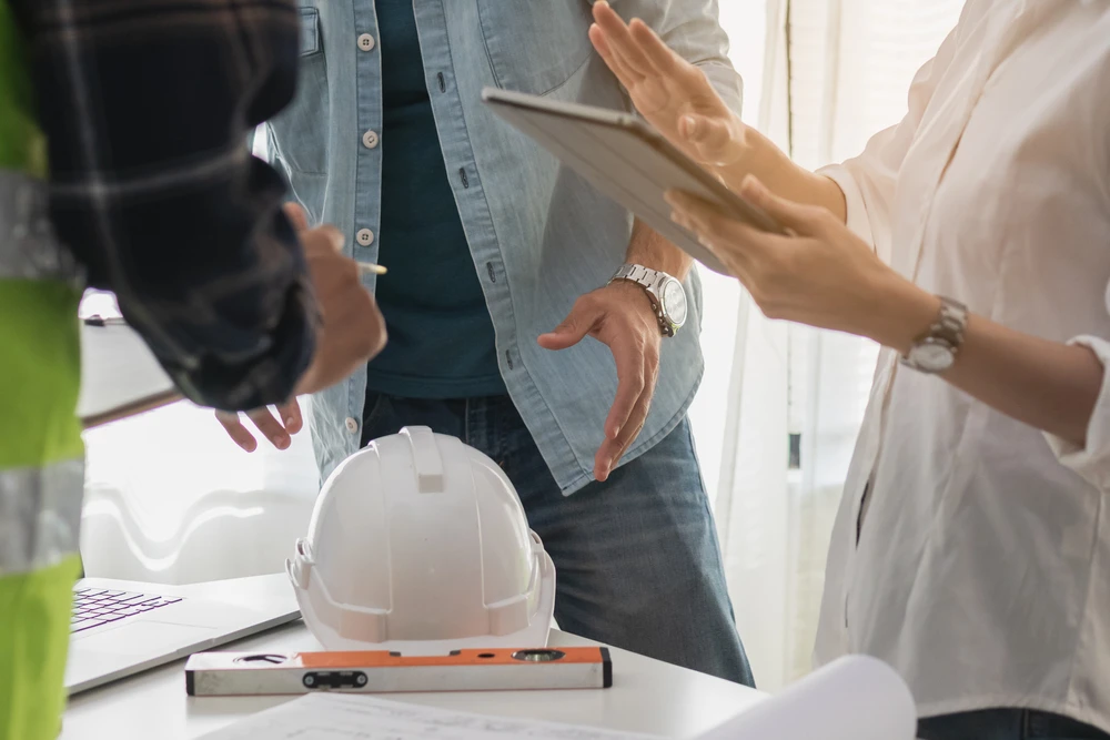 Team, young man and woman contractor, partner explain, brainstorm or discussing job at workplace
