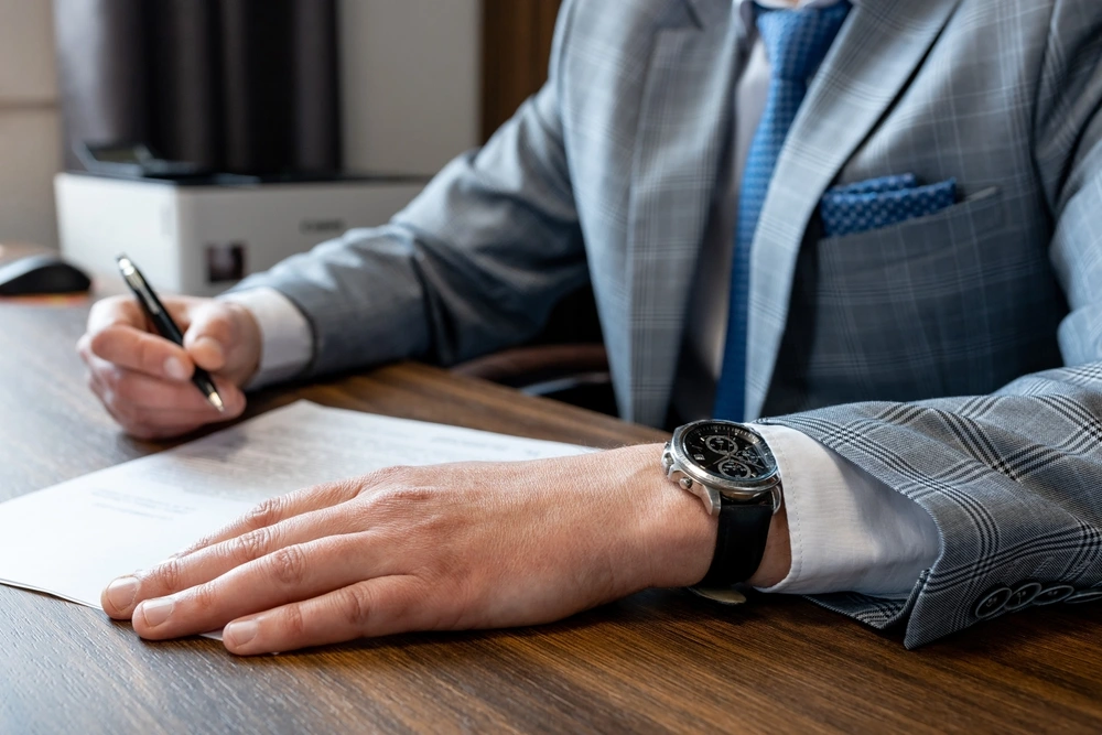 Close up business man reaching out sheet with contract agreement proposing to sign