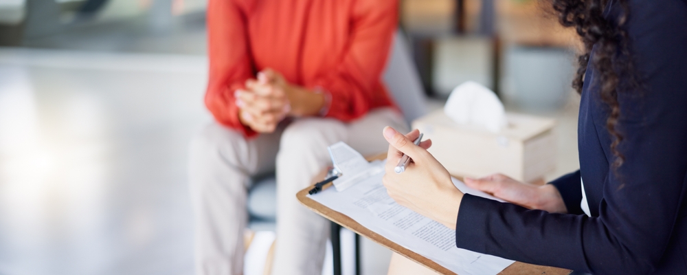Therapist consulting client with checklist for counseling or psychology
