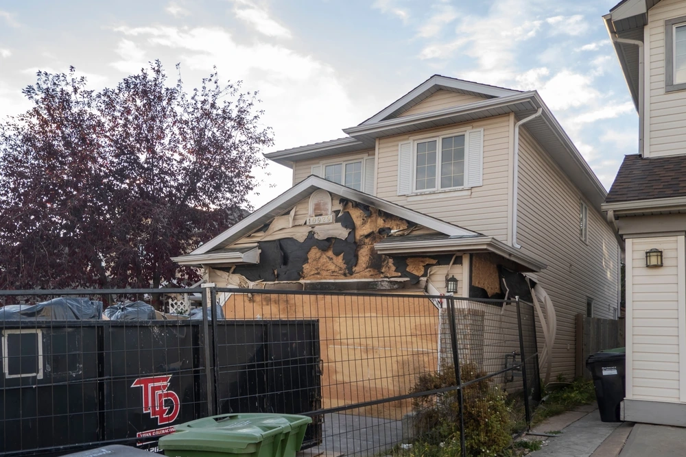 A neighborhood garage roof, which bears the scars of recent accidental fire damage
