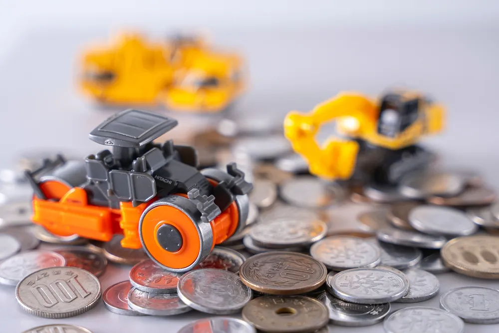 Construction vehicles among coins Savings Investment
