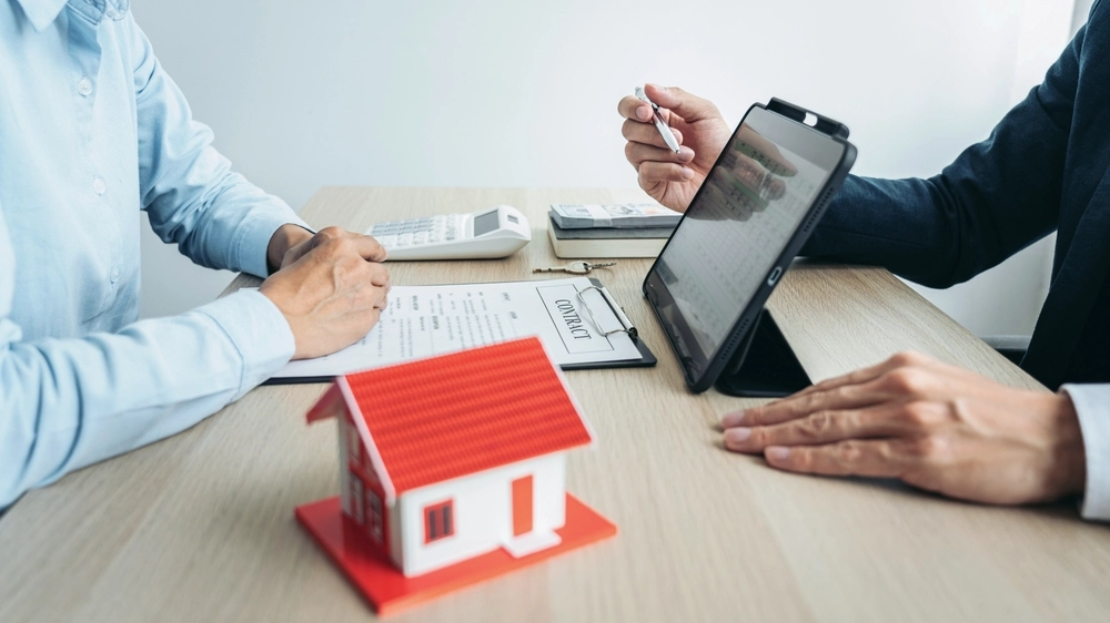 Real estate broker agent consulting the customer to a decision making sign insurance form agreement contract